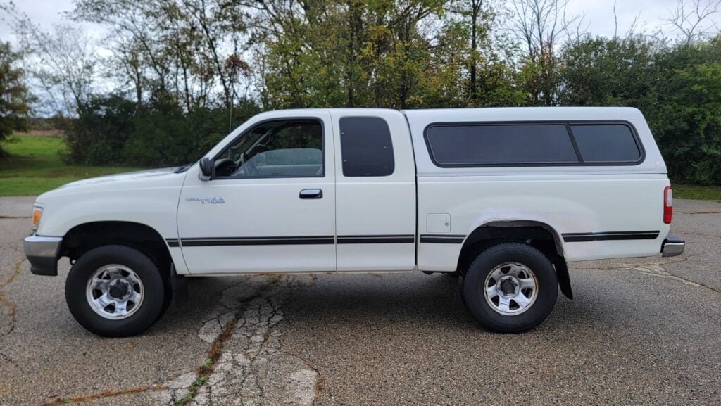 Driver’s side exterior of 1998 Toyota T100 DX 4x4 in Warm White