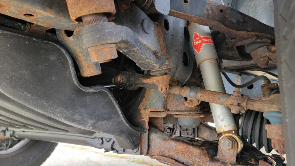 Front driver-side suspension and steering components of 1998 Toyota T100 DX 4x4