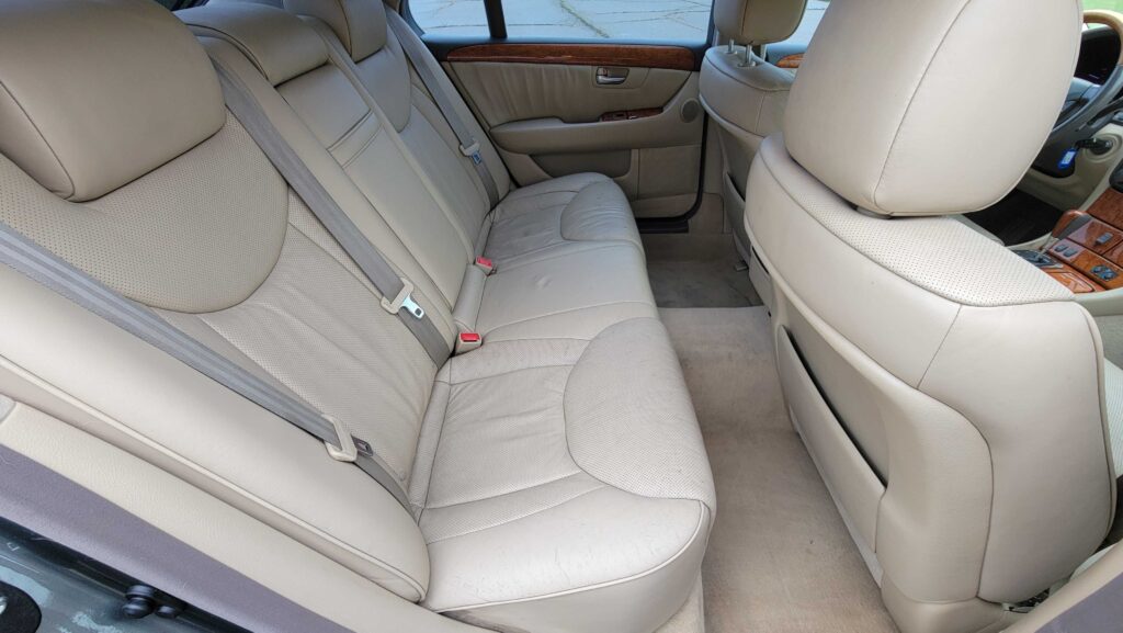 Rear seats and center armrest of 2005 Lexus LS430 in tan leather