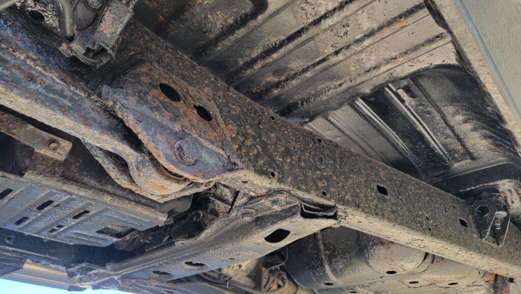 Undercarriage frame rails of 1994 Toyota Land Cruiser green triple locked