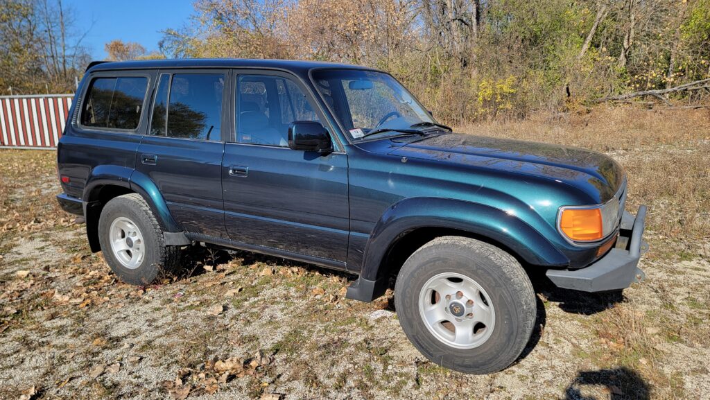 Passenger side exterior view of 1994 Toyota Land Cruiser green triple locked