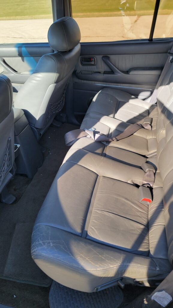 Rear seat interior of 1994 Toyota Land Cruiser green triple locked
