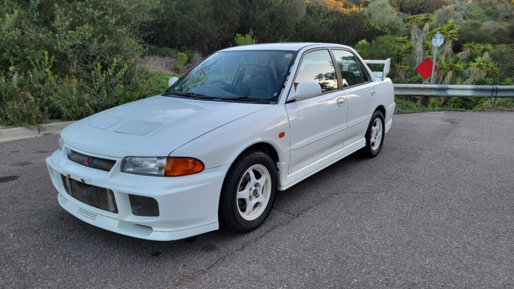 1995-mitsubishi-evo3-front-passenger-angle-white2-taninjdm 1995 Mitsubishi Evo 3 front passenger-side angle - close up