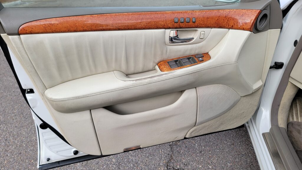Driver door panel with woodgrain trim
