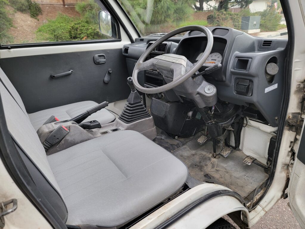 Front seats and driver area of 1993 Mitsubishi Minicab interior
