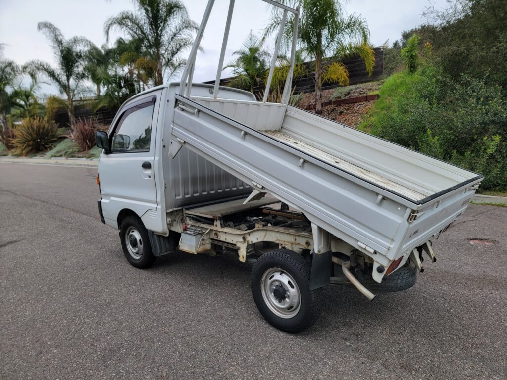 Rear passenger-side angle of Minicab dump truck