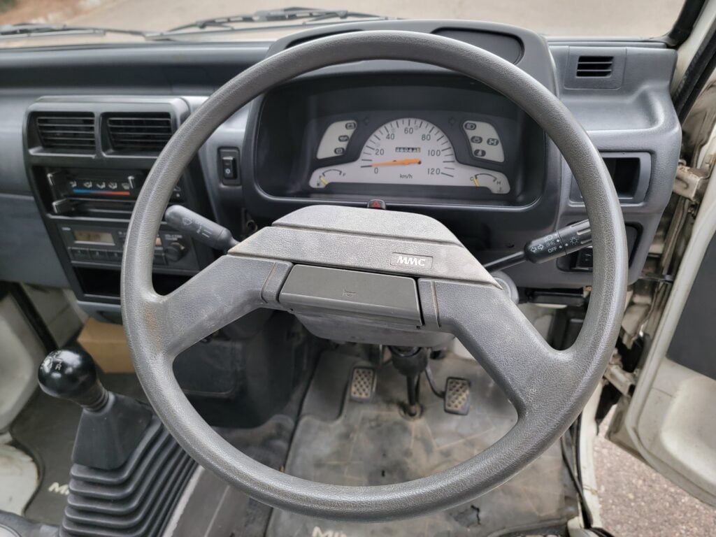 Steering wheel and gauge cluster of 1993 Mitsubishi Minicab