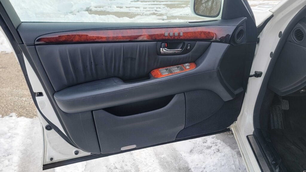 Driver door panel with black leather and wood trim on 2005 Lexus LS430