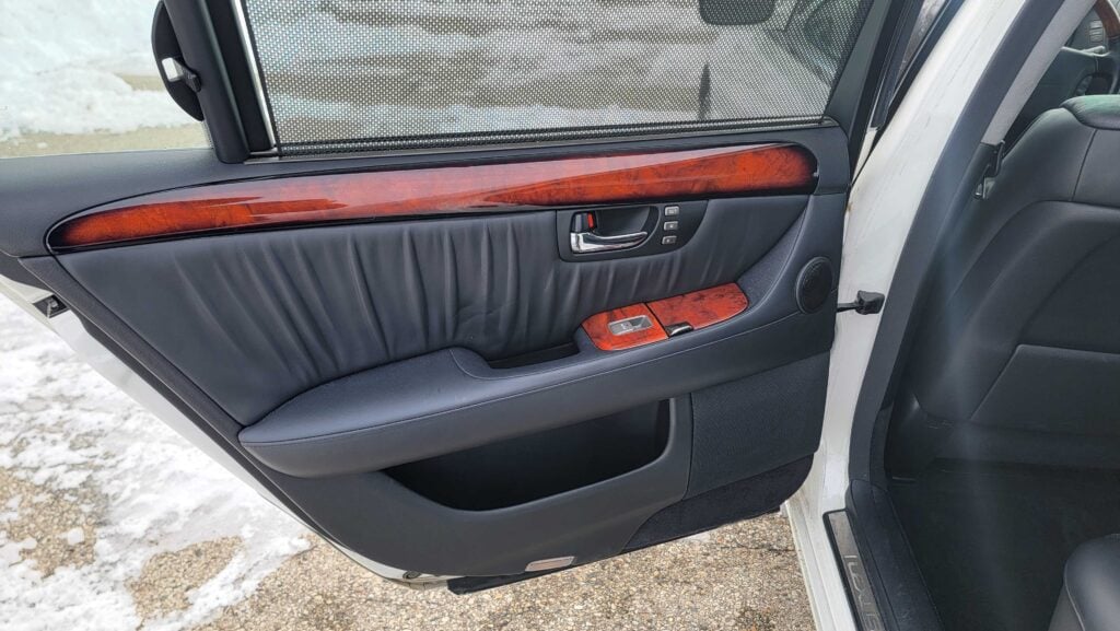 Rear driver-side door panel with wood trim