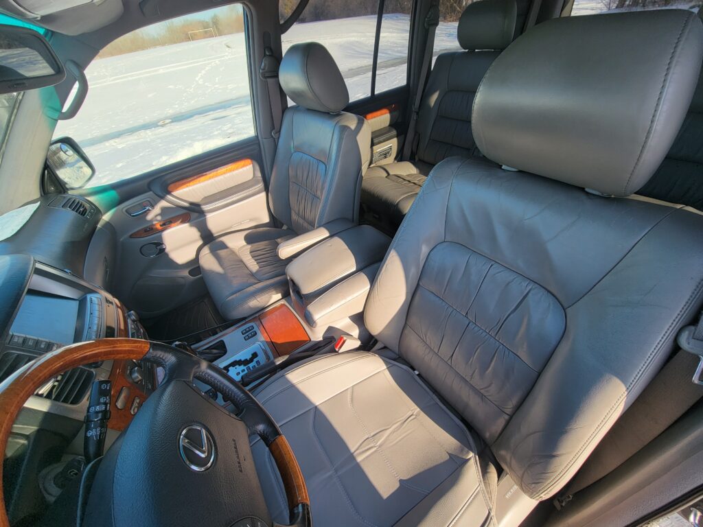 Front seats and center console interior view of Lexus LX470