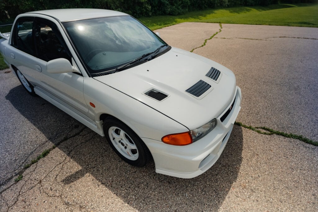 1995-mitsubishi-evo-III-scotia-white-modified-280-awhp-passenger-side-front-side-top-angle-taninjdm 1995 Mitsubishi EVO 3 Driver Front angle high view