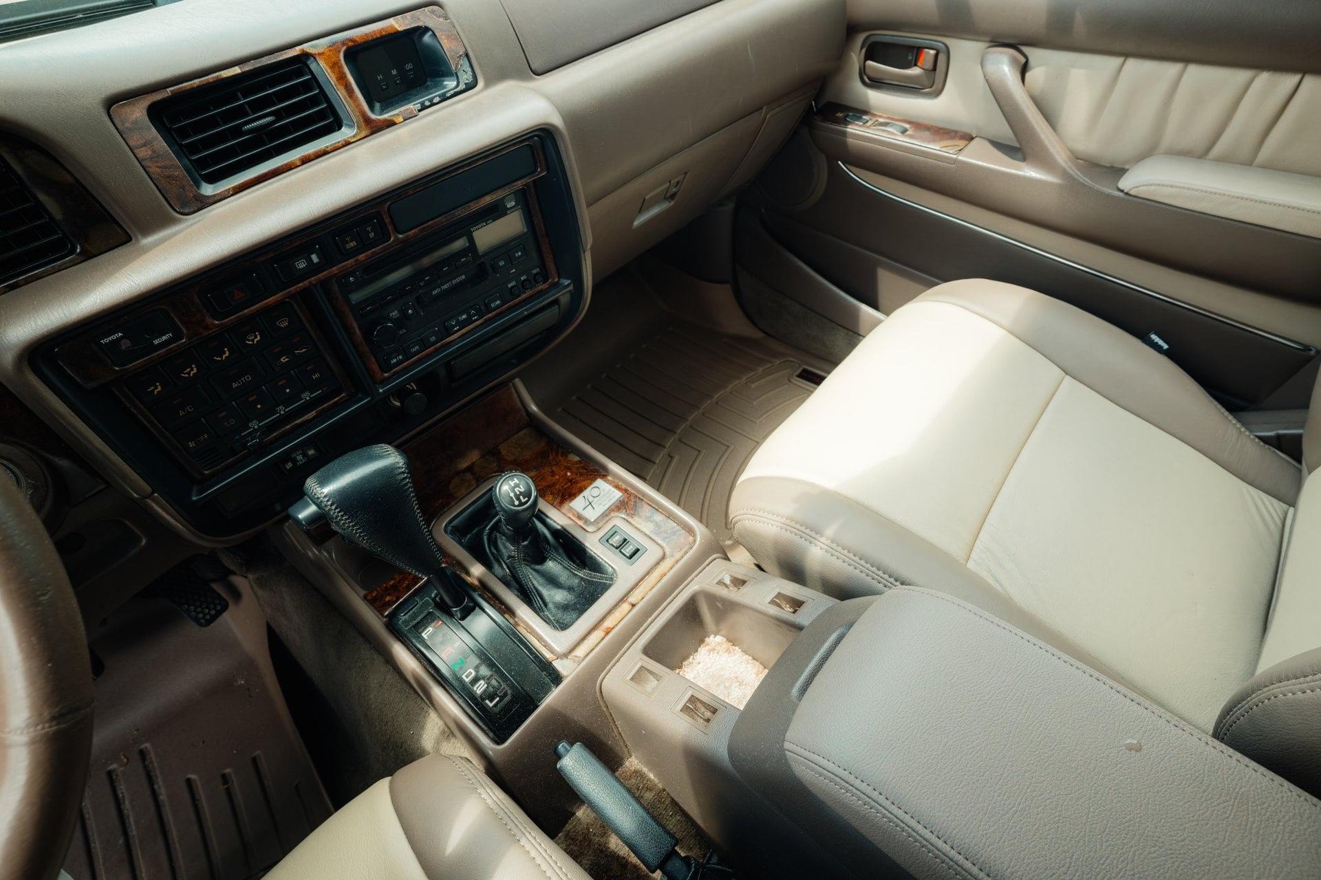 Tan front cabin, automatic gear selector and transfer-case controls in the 1997 Toyota Land Cruiser