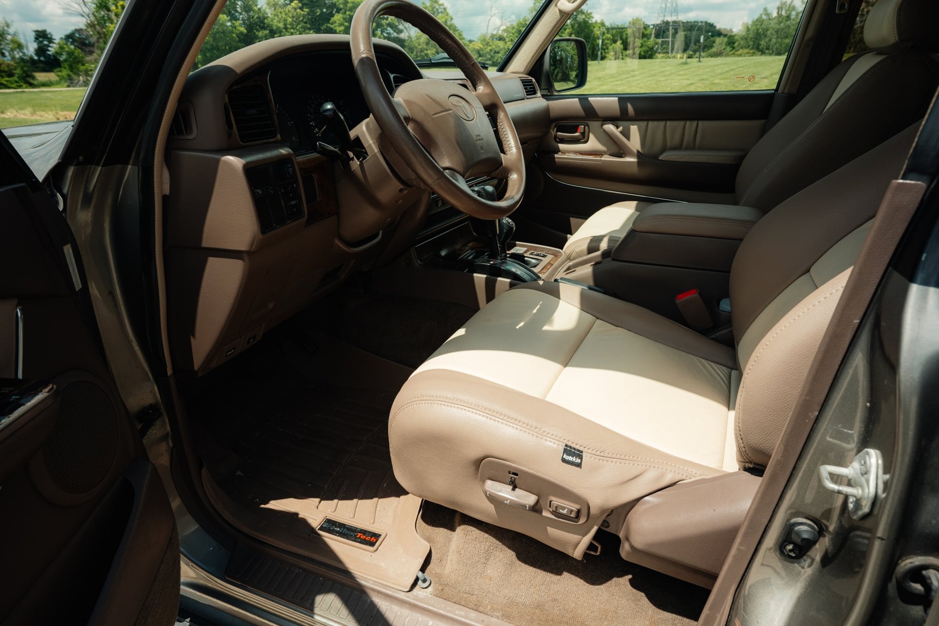 Tan Katzkin-covered driver seat and cabin in the 1997 Toyota Land Cruiser 40th Anniversary